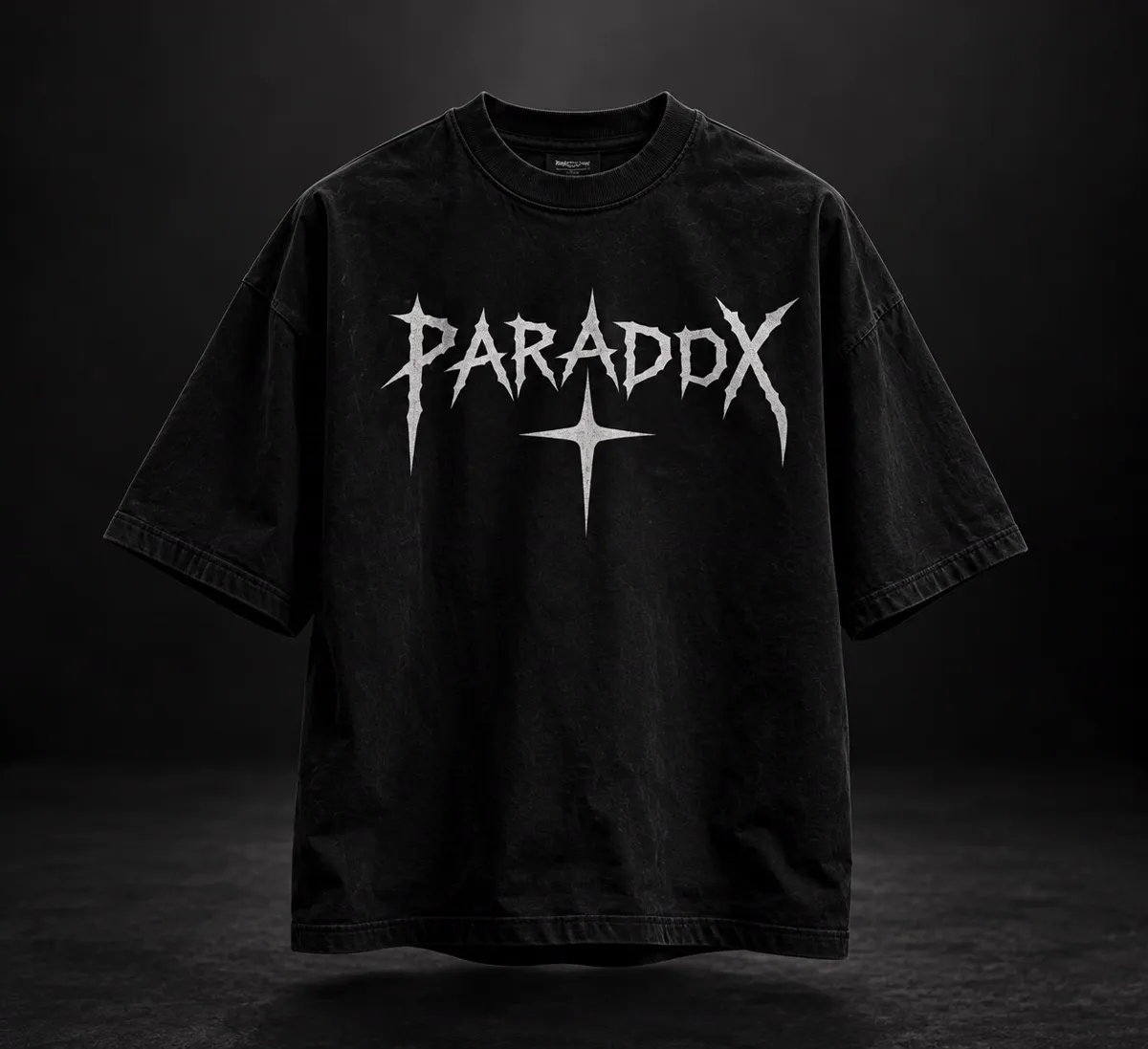 Black oversized T-shirt, front: spiky white PARADOX lettering with a star