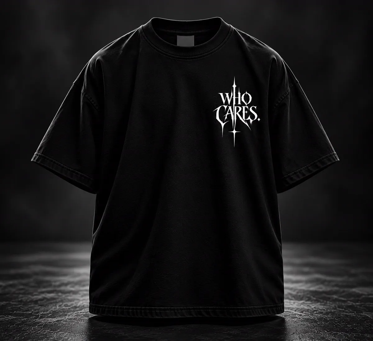 Black oversized T-shirt, front: small WHO CARES chest print in white gothic lettering